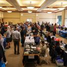 Overview of room with job seekers and employers during a Career Fair